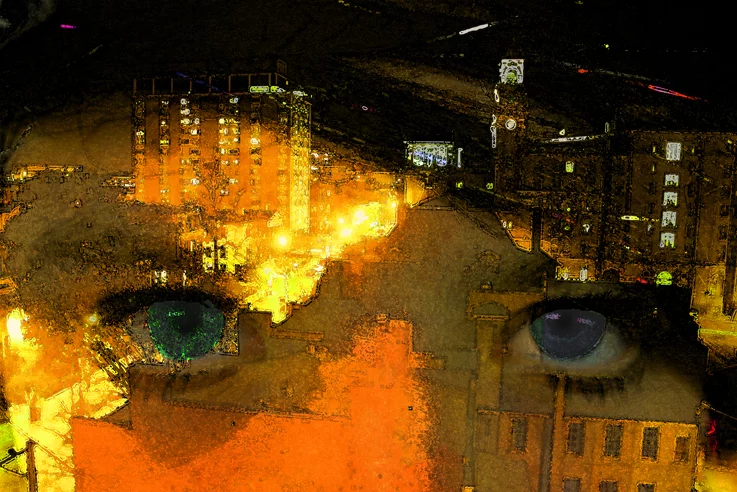 A pair of eyes overlaid on top of a city skyline